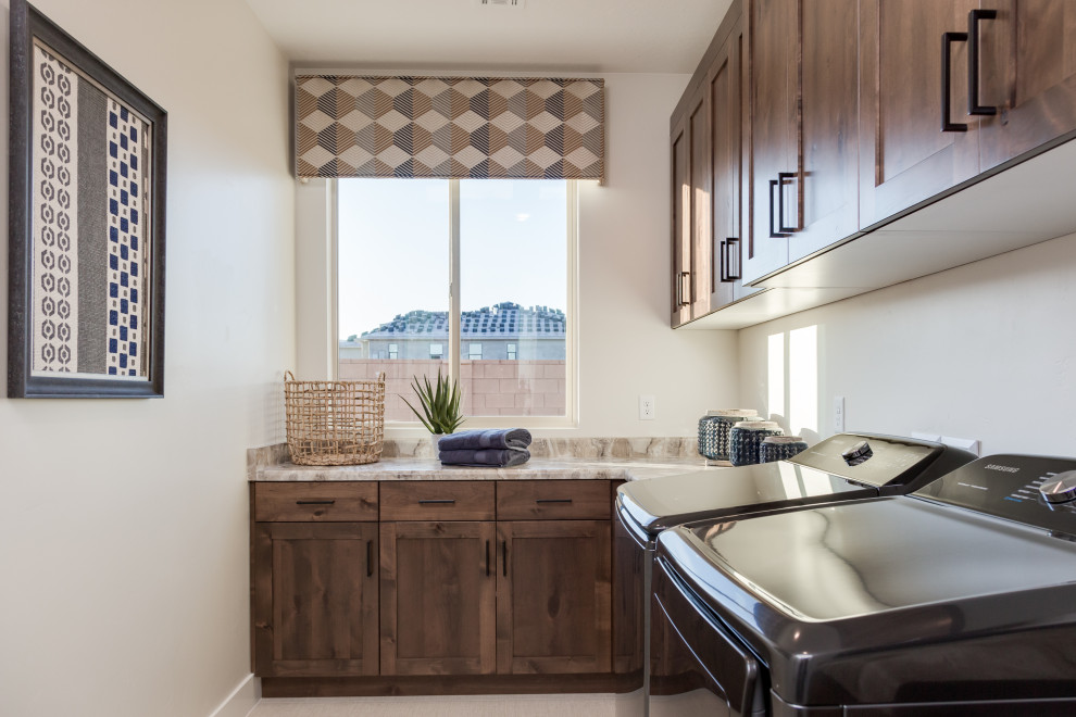 Photo of a mid-sized l-shaped dedicated laundry room in Salt Lake City with shaker cabinets, medium wood cabinets, beige walls, a side-by-side washer and dryer, beige floor and beige benchtop.