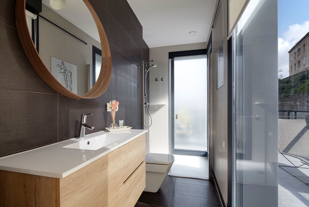 Inspiration for a small modern 3/4 bathroom in Other with flat-panel cabinets, light wood cabinets, a curbless shower, black walls, an integrated sink, a hinged shower door and white benchtops.