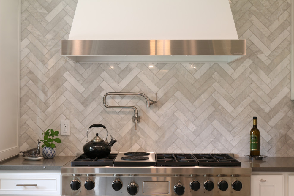 Mid-sized u-shaped ceramic tile, beige floor and exposed beam eat-in kitchen photo in Denver with a single-bowl sink, flat-panel cabinets, white cabinets, quartz countertops, gray backsplash, marble backsplash, stainless steel appliances, an island and gray countertops