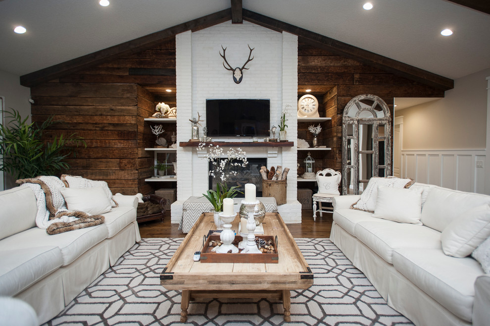 Inspiration for a mid-sized country open concept family room in Jacksonville with medium hardwood floors, a brick fireplace surround, a wall-mounted tv, brown walls and a standard fireplace.