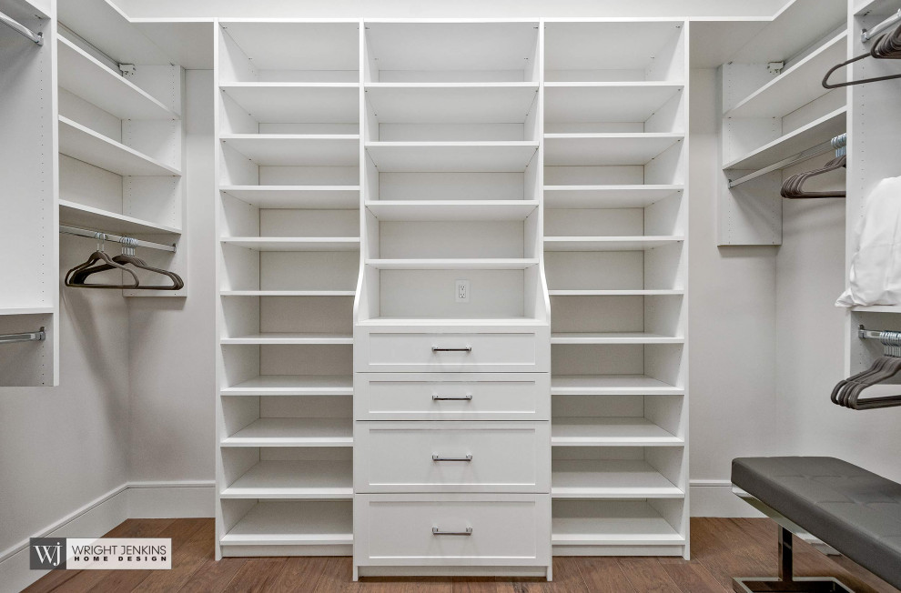 Walk-in closet - mid-sized contemporary gender-neutral medium tone wood floor and beige floor walk-in closet idea in Other with recessed-panel cabinets and white cabinets