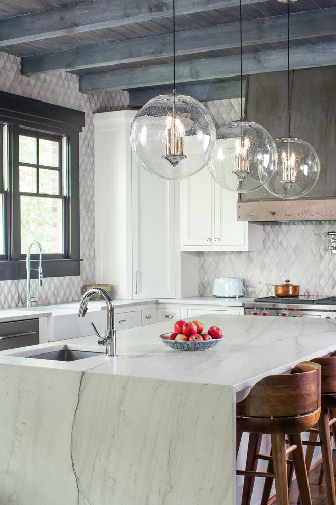 Design ideas for a large transitional l-shaped open plan kitchen in Atlanta with a farmhouse sink, beaded inset cabinets, white cabinets, quartzite benchtops, white splashback, limestone splashback, stainless steel appliances, dark hardwood floors and with island.