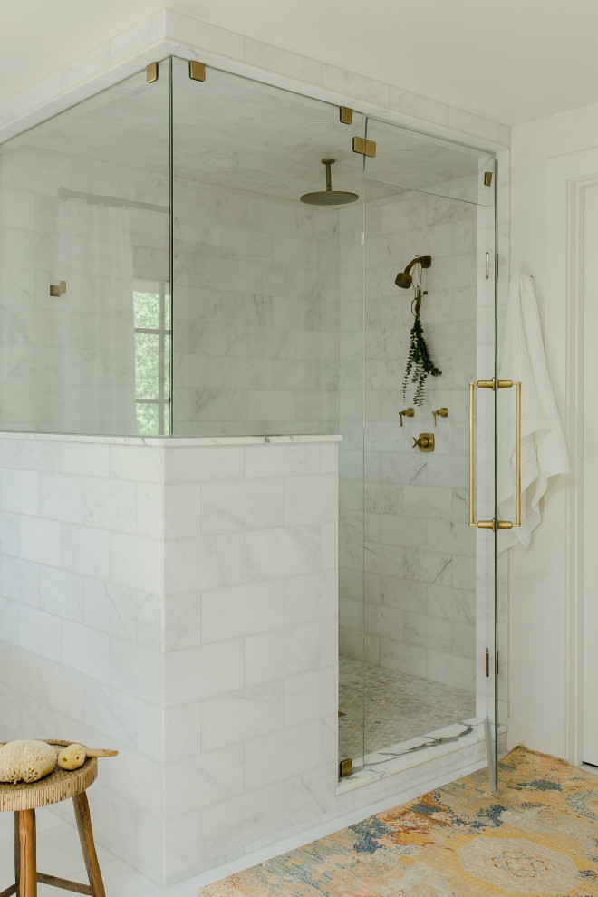 Photo of a large transitional master bathroom in Denver with a corner shower, white tile, white walls, a hinged shower door, porcelain floors and white floor.