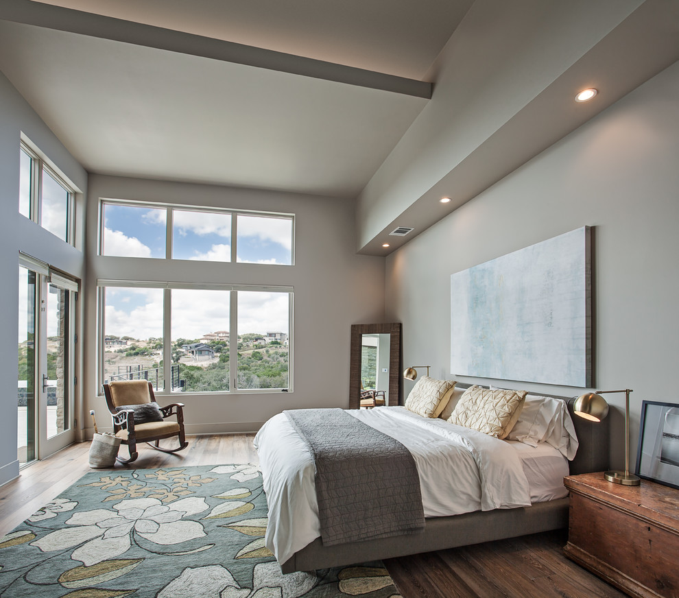 Design ideas for a mid-sized contemporary master bedroom in Austin with beige walls, dark hardwood floors, no fireplace and brown floor.