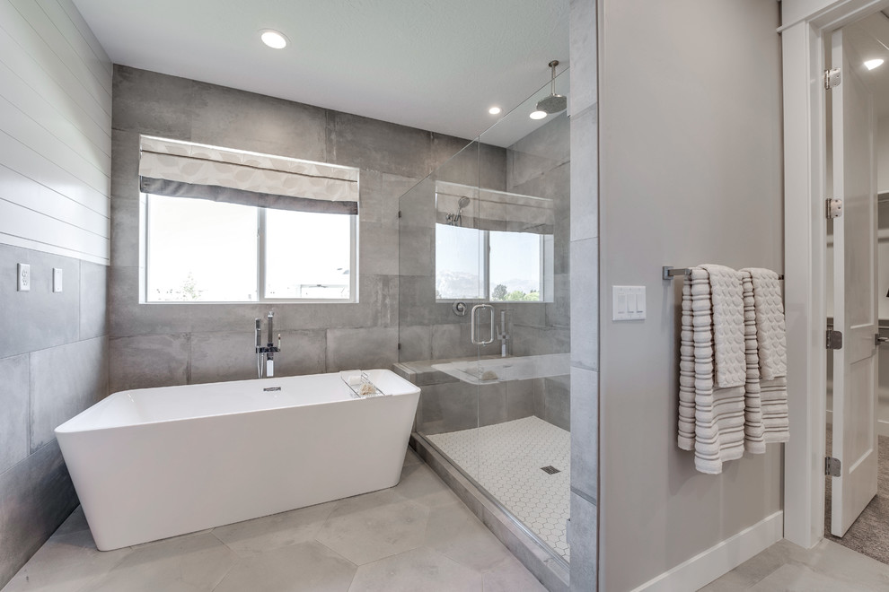 Large traditional master bathroom in Salt Lake City with recessed-panel cabinets, dark wood cabinets, a freestanding tub, a corner shower, gray tile, ceramic tile, grey walls, ceramic floors, an undermount sink, granite benchtops, grey floor and a hinged shower door.