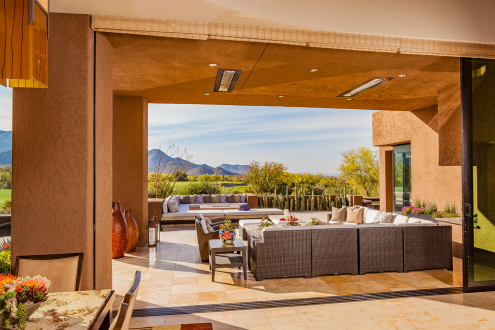 Photo of a large backyard patio in Phoenix with a fire feature, no cover and tile.