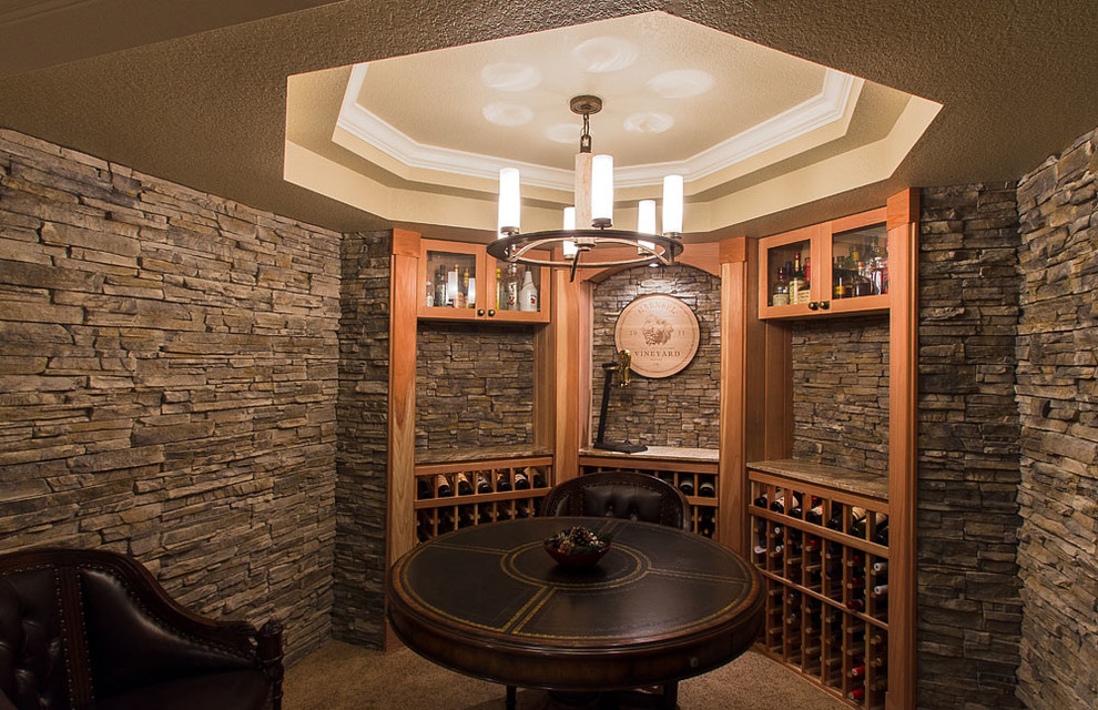 Photo of an expansive traditional wine cellar in Denver with travertine floors and storage racks.