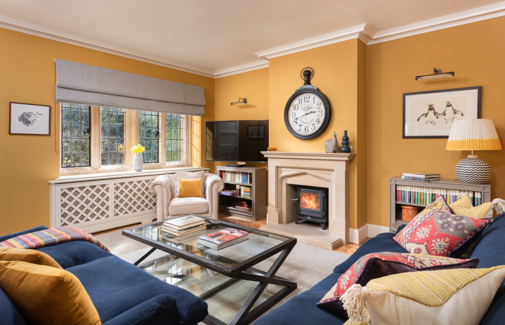 Design ideas for a mid-sized traditional family room in Other with yellow walls and a standard fireplace.