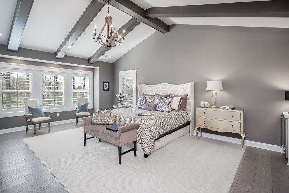 Design ideas for an expansive transitional master bedroom in Charlotte with grey walls, light hardwood floors and vaulted.