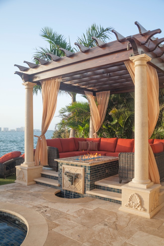 Photo of a small mediterranean backyard patio in Tampa with an outdoor kitchen and a pergola.