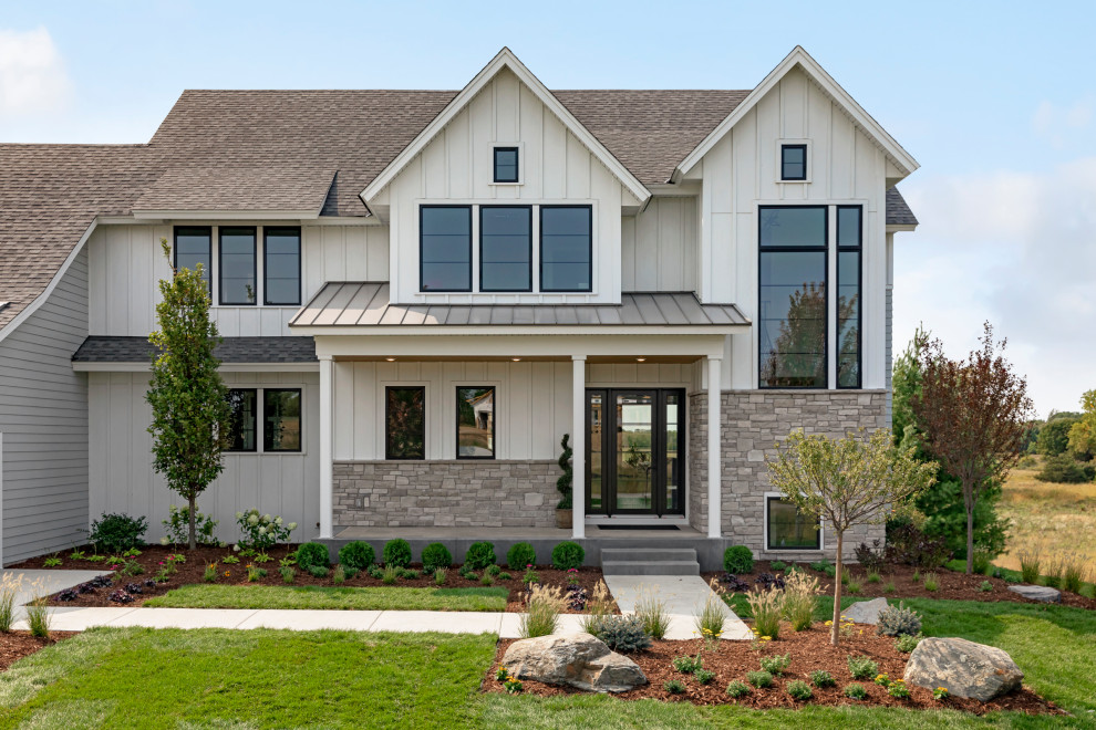 Design ideas for a large country two-storey white exterior in Minneapolis with a mixed roof.