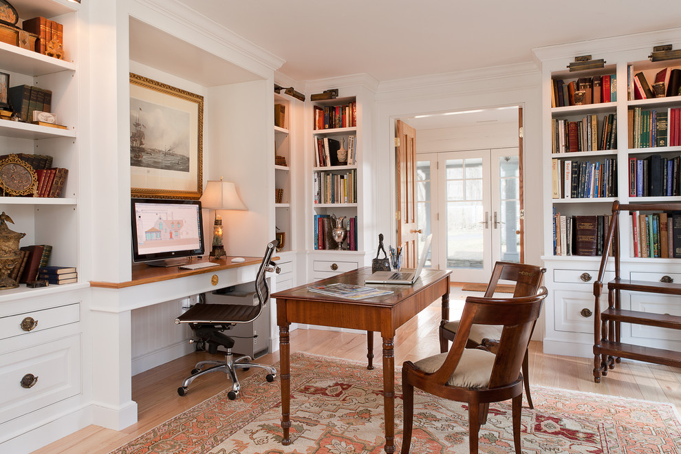 Inspiration for a traditional home office in New York with white walls.