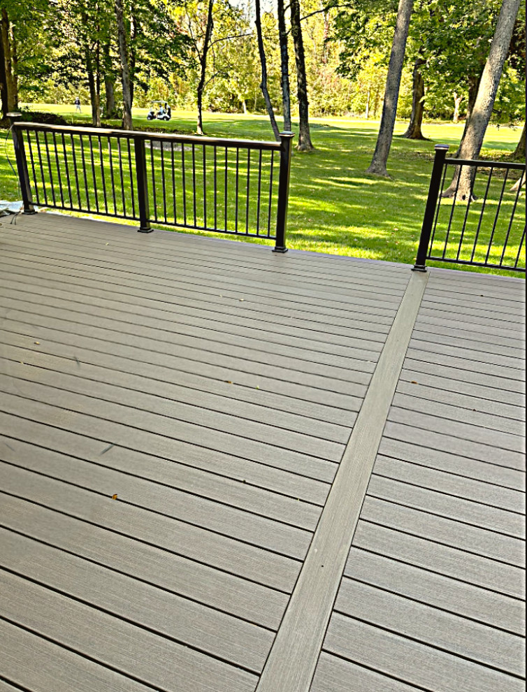 Example of a large minimalist backyard ground level metal railing deck design in Indianapolis