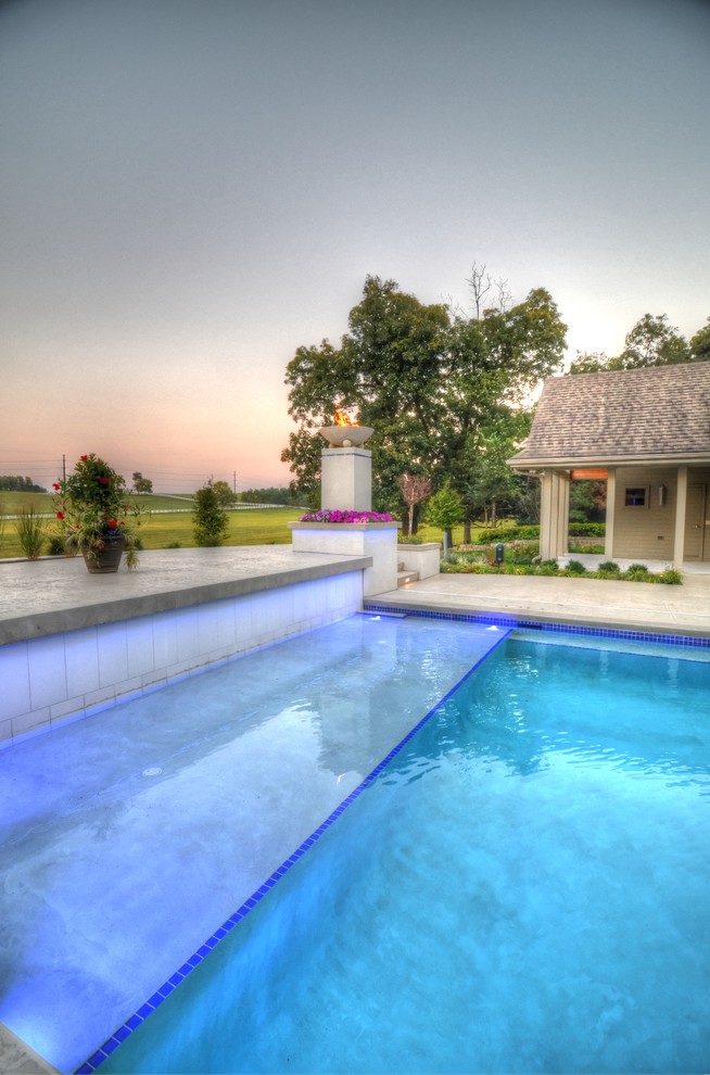 Inspiration for a large transitional backyard concrete paver and rectangular natural hot tub remodel in Cedar Rapids
