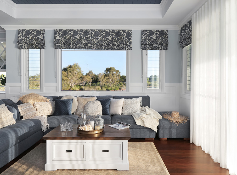 Inspiration for a large beach style open concept family room in Sunshine Coast with multi-coloured walls, dark hardwood floors, a wall-mounted tv, brown floor, coffered and decorative wall panelling.