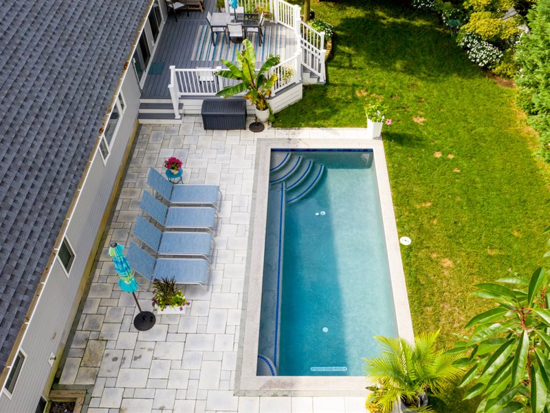 Inspiration for a small transitional backyard concrete paver and rectangular pool remodel