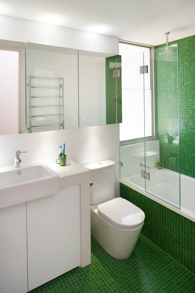 This is an example of a contemporary kids bathroom in New York with green tile, mosaic tile, an alcove tub, a shower/bathtub combo and mosaic tile floors.