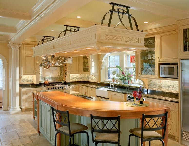 Inspiration for a large traditional kitchen in Boston with an undermount sink, recessed-panel cabinets, beige cabinets, marble benchtops, blue splashback, cement tile splashback, stainless steel appliances, travertine floors and with island.