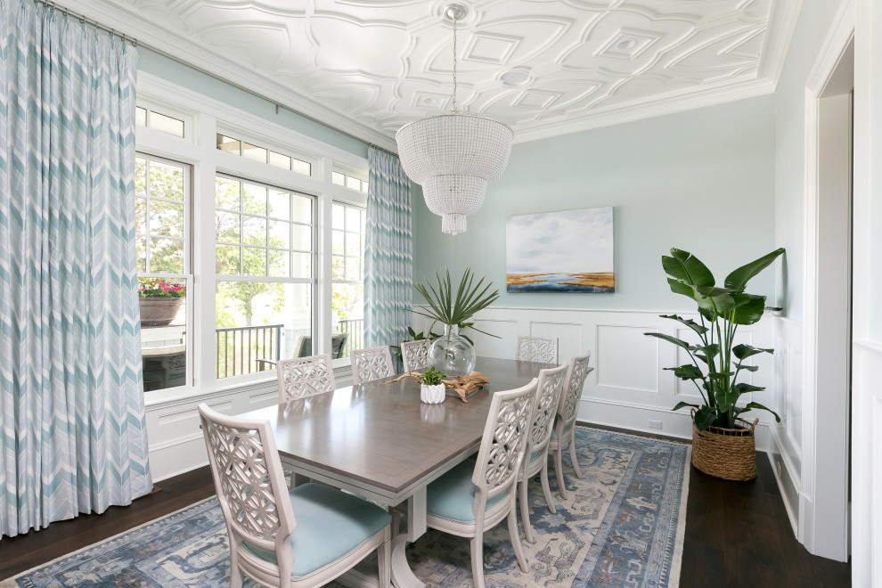 Beach style separate dining room in Charleston with blue walls, dark hardwood floors and no fireplace.