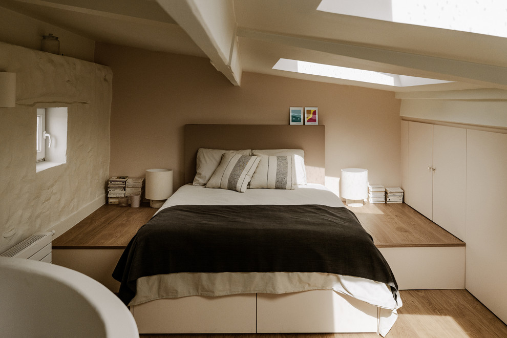 Inspiration pour une chambre parentale méditerranéenne de taille moyenne avec un mur beige et parquet clair.