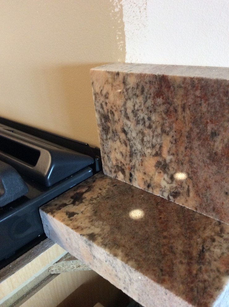 Slide in GE range with full height granite backsplash