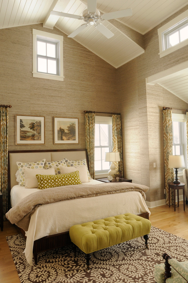 Photo of a country master bedroom in Other with beige walls and light hardwood floors.