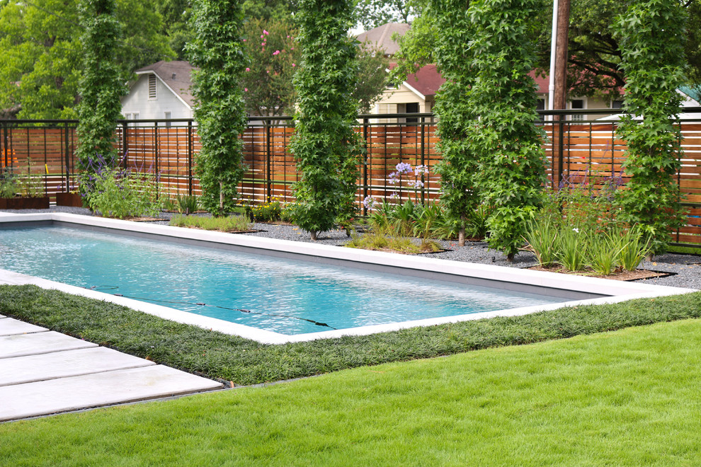 Design ideas for a modern rectangular lap pool in Houston with concrete slab.