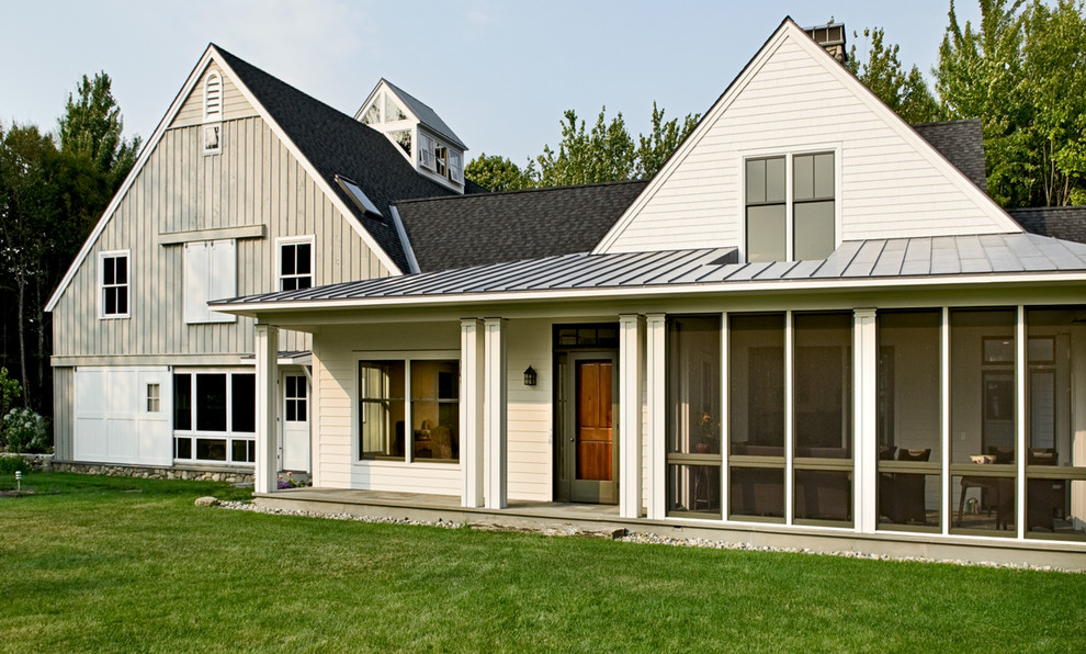 Inspiration for a mid-sized country two-storey exterior in Portland Maine with wood siding and a mixed roof.