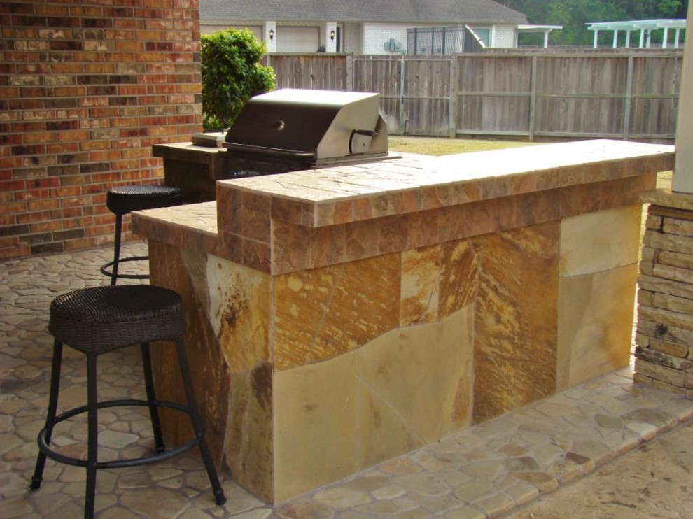 Inspiration for a mid-sized modern backyard patio in Houston with an outdoor kitchen, natural stone pavers and a gazebo/cabana.