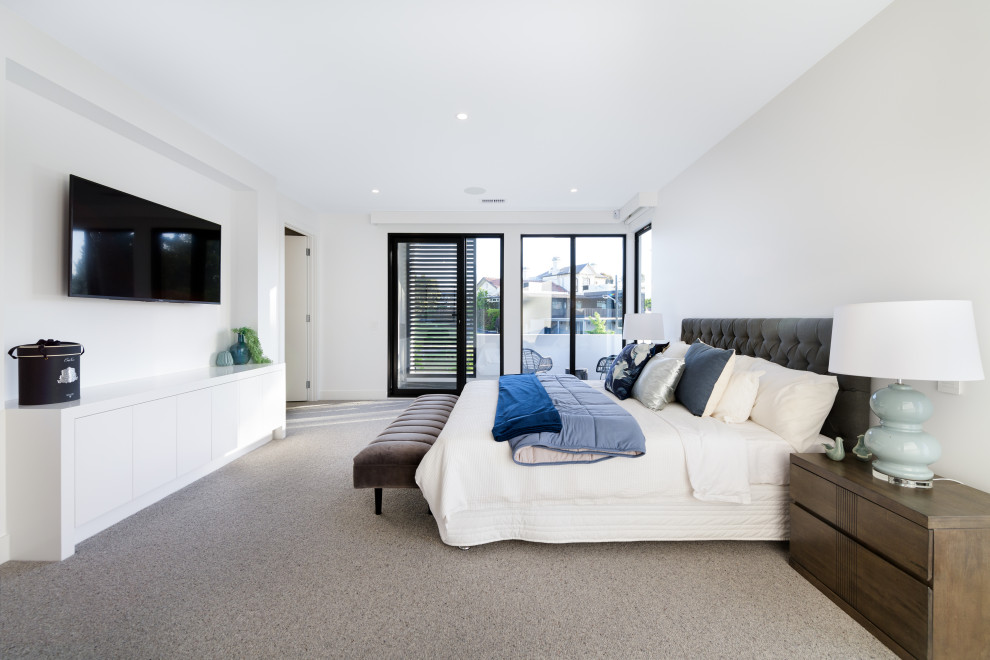 Photo of a large contemporary master bedroom in Melbourne with white walls, carpet and grey floor.