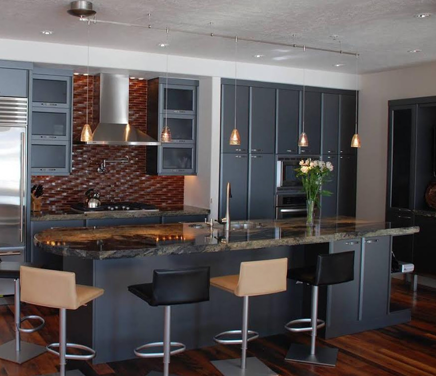 Inspiration for a mid-sized modern single-wall open plan kitchen in Salt Lake City with an undermount sink, flat-panel cabinets, blue cabinets, granite benchtops, brown splashback, stainless steel appliances, dark hardwood floors, with island, mosaic tile splashback, brown floor and brown benchtop.