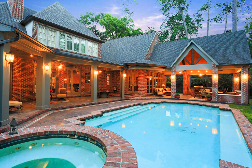 Large traditional backyard rectangular lap pool in Houston with stamped concrete and a hot tub.