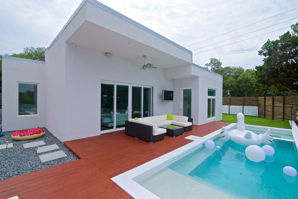This is an example of a small contemporary backyard rectangular lap pool in Jacksonville with a hot tub and decking.