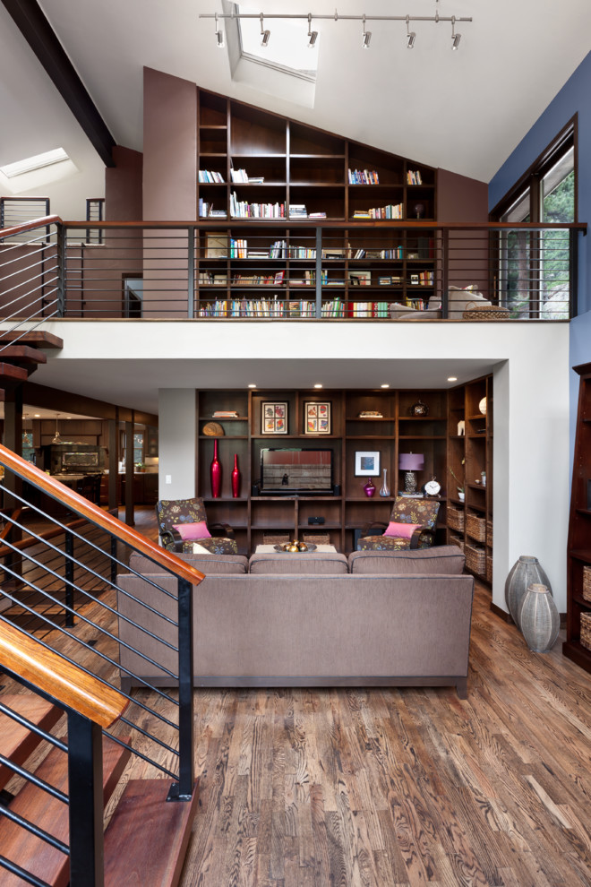 This is an example of a contemporary family room in Denver with brown walls.