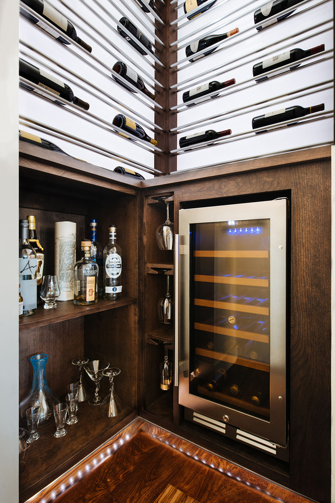Inspiration for a small modern l-shaped wet bar in Portland with open cabinets, dark wood cabinets, wood benchtops and medium hardwood floors.