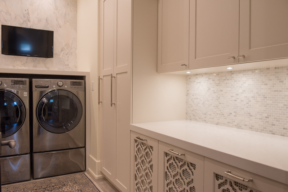 Design ideas for a mediterranean laundry room in Vancouver with shaker cabinets, white cabinets, quartz benchtops, ceramic floors and a side-by-side washer and dryer.
