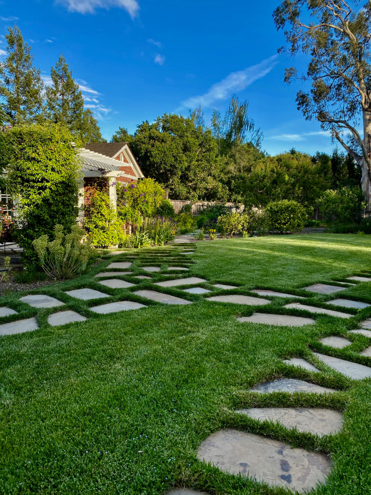 Photo of a large contemporary backyard partial sun formal garden for summer in San Francisco with a garden path and natural stone pavers.