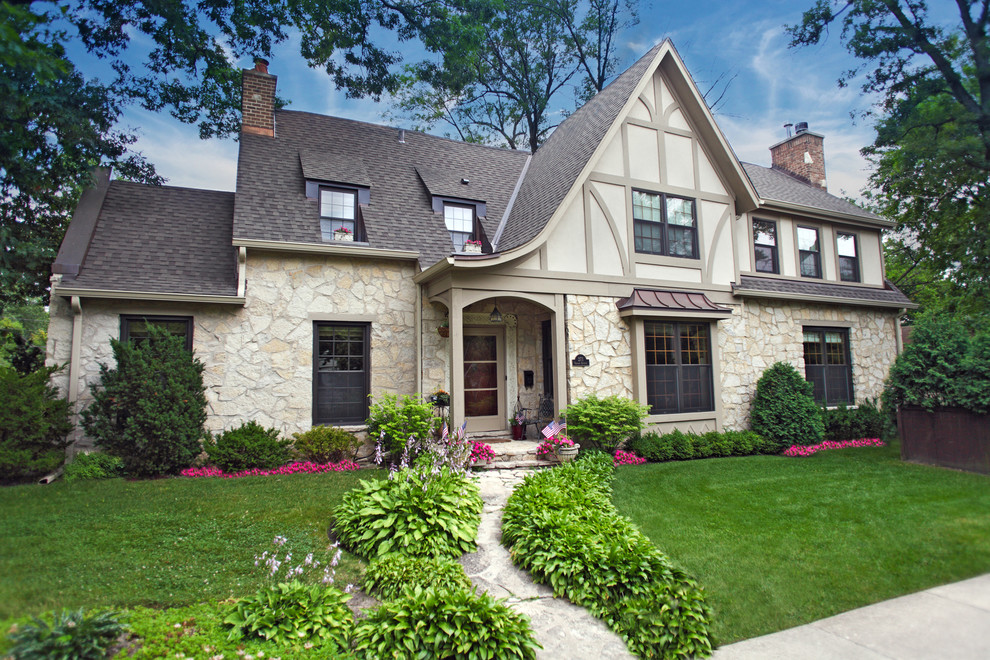 Photo of a traditional two-storey beige exterior in Chicago with mixed siding.