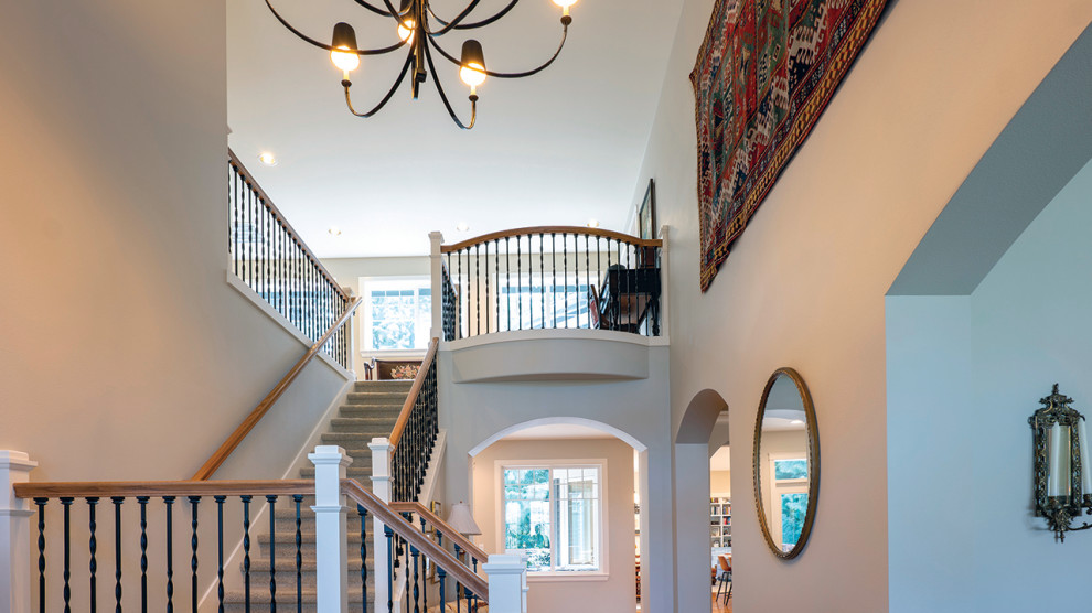 Inspiration for a mid-sized transitional porcelain tile and white floor foyer remodel in Seattle with beige walls and a dark wood front door