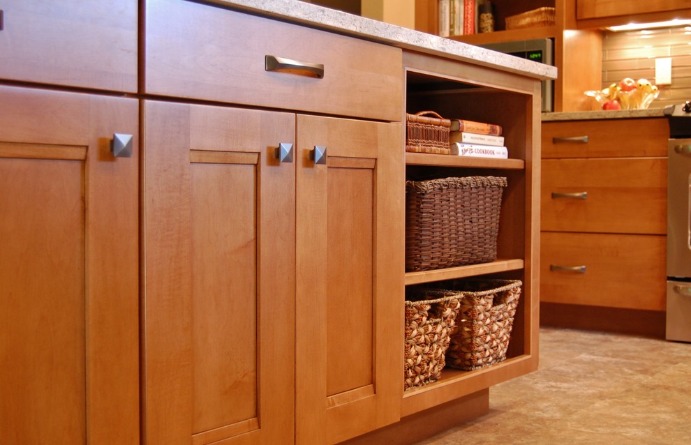Inspiration for a mid-sized transitional l-shaped laminate floor open concept kitchen remodel in Portland with an undermount sink, shaker cabinets, medium tone wood cabinets, quartz countertops, brown backsplash, glass tile backsplash, stainless steel appliances, a peninsula and multicolored countertops