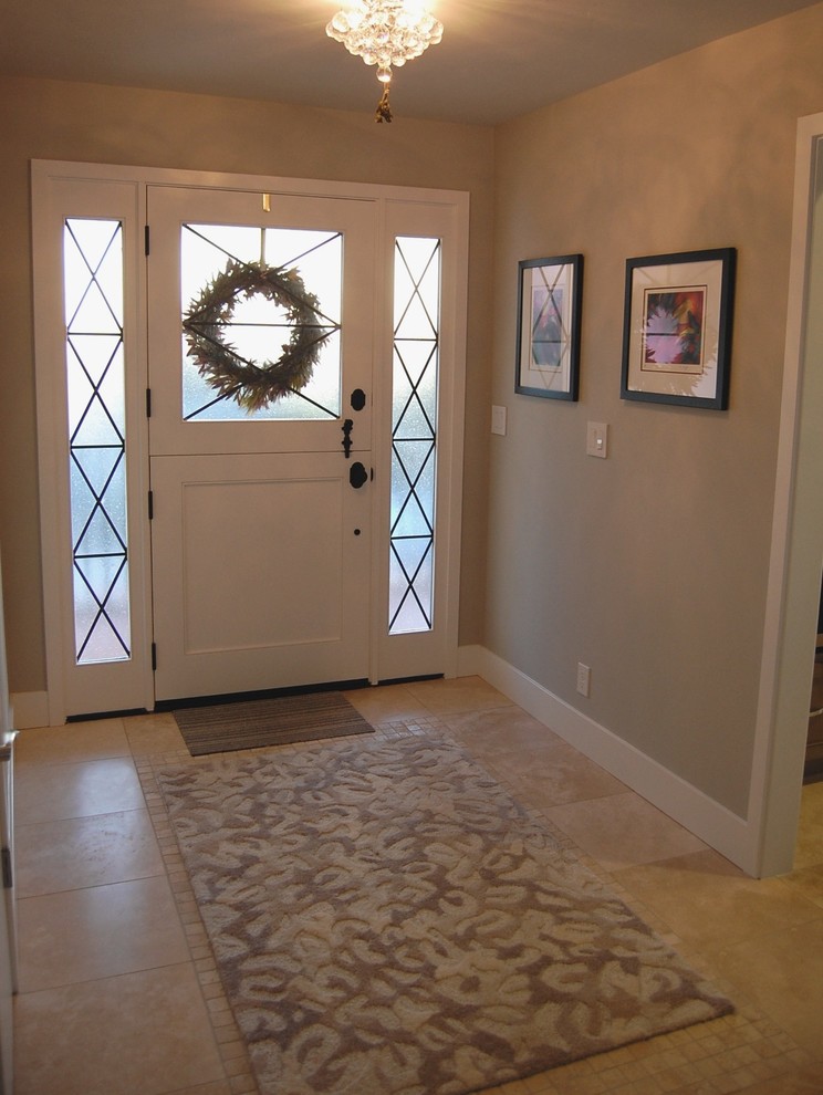 Design ideas for a small transitional foyer in Orange County with beige walls, travertine floors, a dutch front door and a white front door.