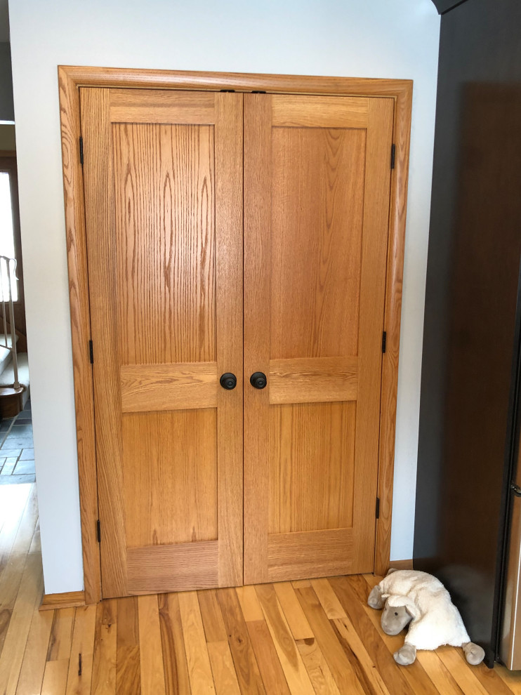 Mid-sized transitional galley light wood floor and brown floor eat-in kitchen photo with an undermount sink, shaker cabinets, black cabinets, quartz countertops, gray backsplash, subway tile backsplash, stainless steel appliances, no island and white countertops