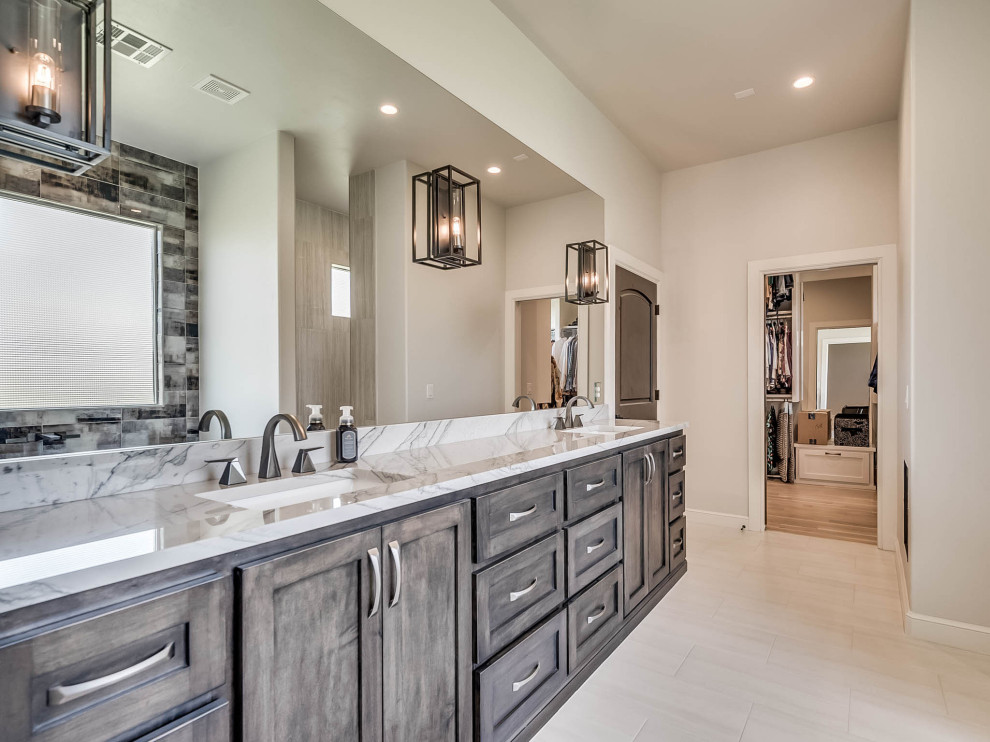 This is an example of a large country bathroom in Oklahoma City with grey cabinets, a freestanding tub, an open shower, black and white tile, glass tile, beige walls, light hardwood floors, an undermount sink, quartzite benchtops, white floor, an open shower, white benchtops, a double vanity and a freestanding vanity.