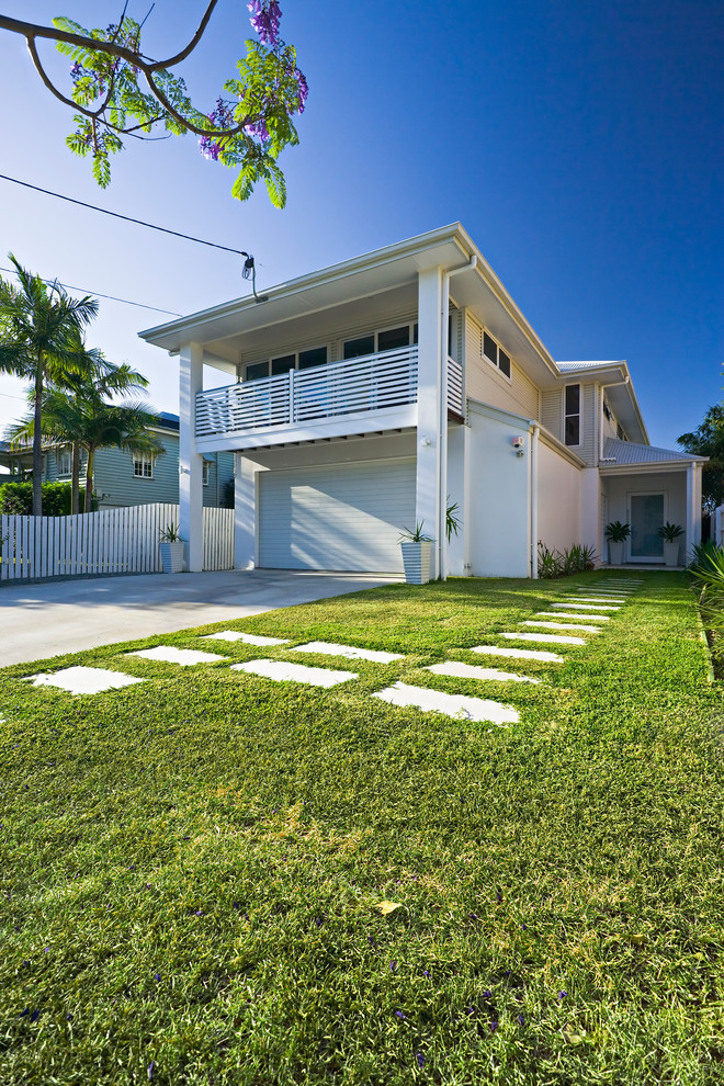 This is an example of a contemporary two-storey white exterior in Brisbane with mixed siding.