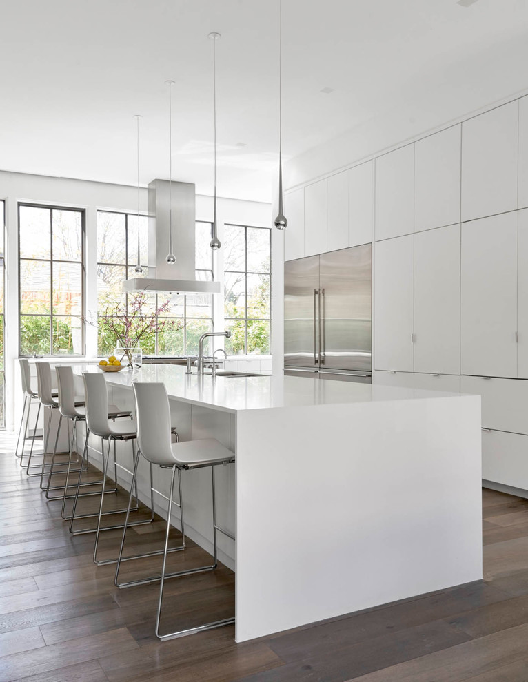 Inspiration for a large contemporary l-shaped open plan kitchen in Dallas with an undermount sink, flat-panel cabinets, white cabinets, quartz benchtops, beige splashback, stainless steel appliances, dark hardwood floors and with island.