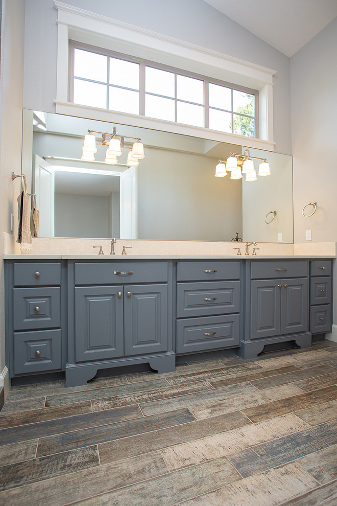 Medium sized traditional shower room bathroom in Portland with shaker cabinets, blue cabinets, all types of toilet, white walls, laminate floors, an integrated sink, brown floors, blue worktops, double sinks and a built in vanity unit.