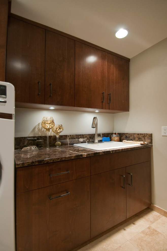 Photo of a small single-wall dedicated laundry room in Other with a drop-in sink, flat-panel cabinets, brown cabinets, laminate benchtops, beige walls, ceramic floors, a side-by-side washer and dryer, beige floor and brown benchtop.