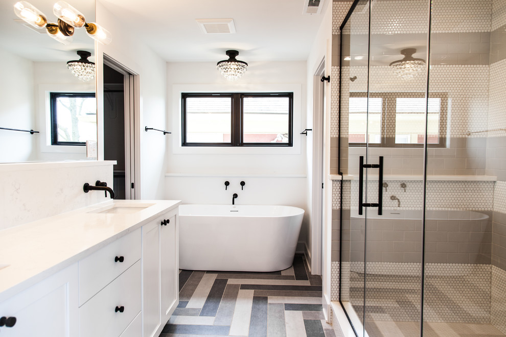 Inspiration for a mid-sized transitional master multicolored tile and porcelain tile porcelain tile freestanding bathtub remodel in Indianapolis with shaker cabinets, white cabinets, white walls, an undermount sink, quartz countertops, a hinged shower door and white countertops