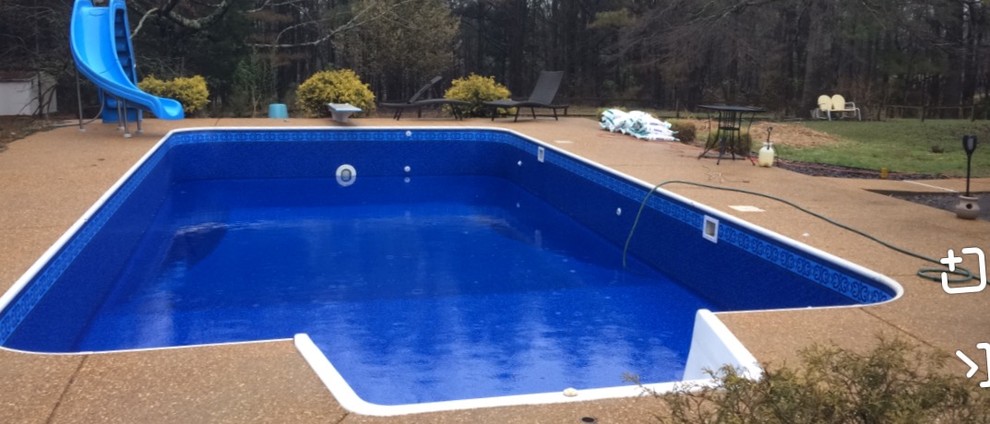 Inspiration for a traditional backyard rectangular pool in Other with a water slide and decomposed granite.