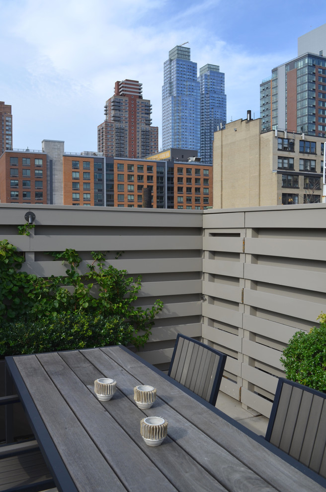 This is an example of a contemporary rooftop and rooftop deck in New York with no cover.